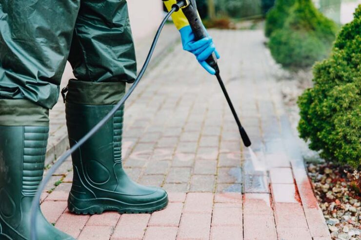 Man,Cleaning,Red,,Conrete,Pavement,Block,Using,High,Pressure,Water